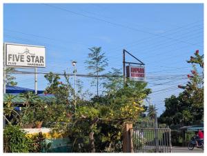 a sign for a five star cafe with a tree at Amparo Residence, Makiling Room in Hilongos