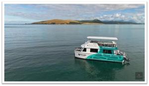 a boat in the water on a large body of water at The Sands Hotel Hokianga in Opononi