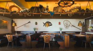 a restaurant with tables and chairs and items on the wall at Hotel Restaurant Seestern in Heiligenhafen +1 photo