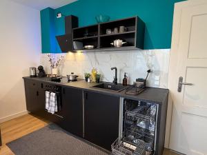 a kitchen with a sink and a dishwasher at Home&Living - Casa Nova in Meerbusch +3 photos