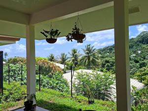 a view from the porch of a house at Bungalow Hoarai in Uturoa