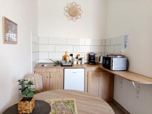 a small kitchen with a sink and a microwave at Panoráma Apartman in Vác