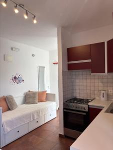 a living room with a couch in a kitchen at Guesthouse Kamarin in Pomena