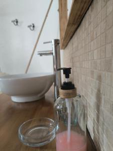 a bottle of soap on a table in a bathroom at L’Antre d’Eux in Carcassonne +31 photos