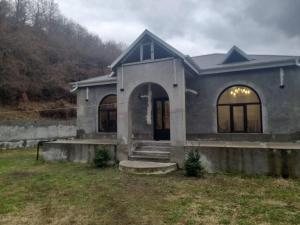 a house with a blue roof at Qax home in Qax