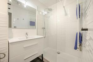 a white bathroom with a sink and a shower at Appartement calme, clim, patio XXL, piscine&parking in Hyères +46 photos