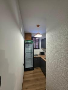 a kitchen with a refrigerator in the middle of a hallway at Tijekova koča in Hočko Pohorje