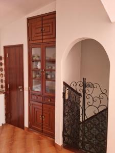 a room with a wooden cabinet and a door at Casa Nelinha by Rosado in Luz