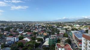 a city with buildings and mountains in the background at Peppers Crib in Manila