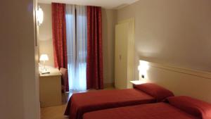 Voodi või voodid majutusasutuse Hotel Cavour toas
