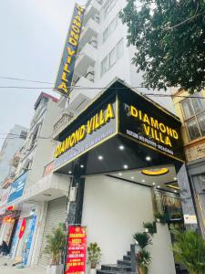a sign for a restaurant in front of a building at Diamond Villa in Hanoi