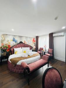a bedroom with a large bed and two chairs at Diamond Villa in Hanoi +72 photos