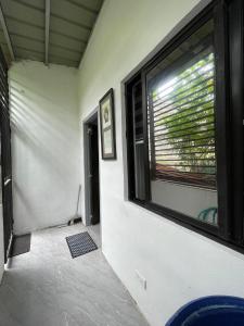 a room with a large window in a house at Lavish style at Laguna by Nelson in Biñan