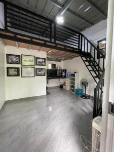 a room with a staircase and a room with a floor at Lavish style at Laguna by Nelson in Biñan