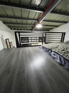 a bedroom with a bed and a wooden floor at Lavish style at Laguna by Nelson in Biñan +4 photos