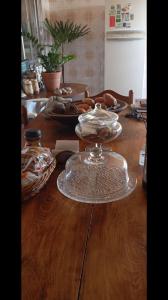 a wooden table with a glass plate on top of it at Pousada da Lú in Jaguarão