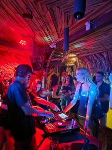 a group of people sitting at a table in a club at Estudio Arena in Brisas de Zicatela