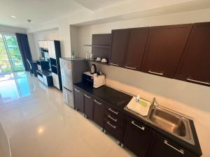 a kitchen with a sink and a refrigerator at Aonang Mountain View A1 in Ao Nang Beach