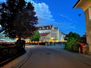 a street in a town at night at Stadthotel Augsburger Hof in Landsberg am Lech
