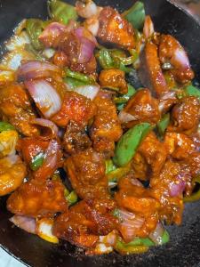a pile of food in a frying pan at Himvilla Kasol in Jāmb