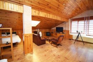 a bedroom with a bed and a television in a room at Villa la cantera in Guadarrama