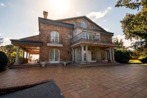 a large brick house with a brick driveway at Villa la cantera in Guadarrama