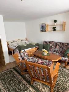 a living room with a couch and a table and chairs at PRIVAT MARIANNA in Žakovce