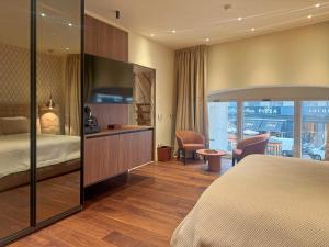 a hotel room with a bed and a desk at AF Duomo - Milano Luxury Suites in Milan