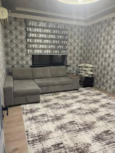a living room with a couch and a rug at Seven Resedens 82-15 in Sergeli