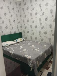 a small bed in a room with a wall at Seven Resedens 82-15 in Sergeli