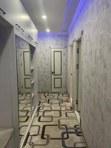 a hallway with a tile floor and two doors at Seven Resedens 82-15 in Sergeli +12 photos