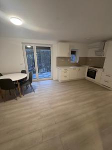 a large kitchen with a table and chairs and a table and a table at Ferienapartments Sternen WOHN 6 in Baiersbronn