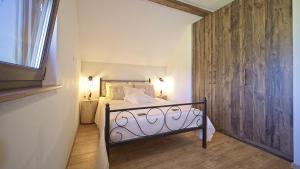 a bedroom with a bed with a wooden wall at Villa Debelo Brdo by Villas Guide in Debelo Brdo +33 photos
