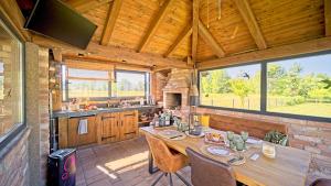 a large kitchen with a wooden table in a cabin at Villa Debelo Brdo by Villas Guide in Debelo Brdo