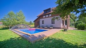 a house with a swimming pool in the yard at Villa Debelo Brdo by Villas Guide in Debelo Brdo