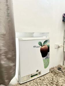 a refrigerator with an image of an apple on it at Casa Flores in Sampong