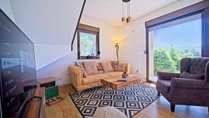 a living room with a couch and a table at Villa Debelo Brdo by Villas Guide in Debelo Brdo