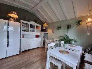 a kitchen with a white table and a white refrigerator at Casa Jetizo in Ontinyent
