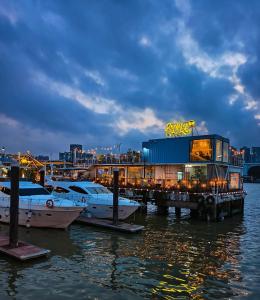 a marina with boats docked in the water at night at 啡诺艺术美居 in Guangzhou