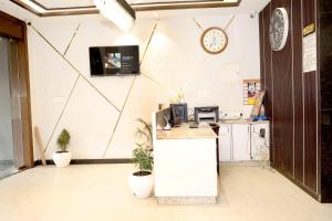 an office with a counter and a clock on the wall at Hotel MM Palace Vairo Cafe Rooftop View Taj Mahal in Tājganj