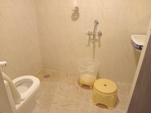 a bathroom with a toilet and a sink and a shower at Siddi Vinayaka hotel in Hyderabad