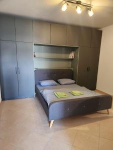 a bedroom with a bed in a room with cabinets at Luxury Bruchi in Durrës