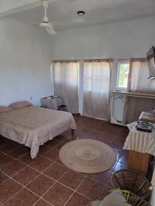 a bedroom with two beds and a rug in a room at Estudio Arena in Brisas de Zicatela