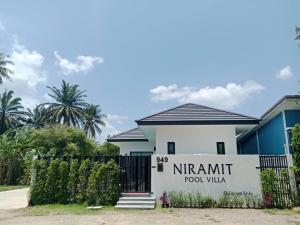 a house with a sign that reads nirmit food villa at Niramit Pool Villa in Ban Chong Phli
