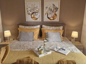 a bed with a tray with glasses on it at Apartment Lidija in Krk