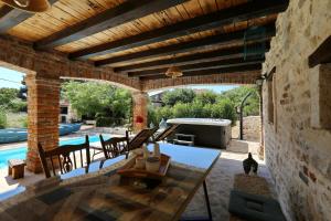 a patio with a table and chairs and a pool at Villa Gland in Nin