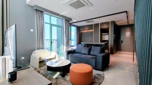 a living room with a couch and a table at La,mer Butik Hotel in Kota Kinabalu