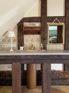 a bathroom with a sink and a mirror at Urikivi Holiday House in Orjaku