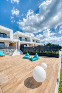 a patio of a house with blue and white pillows at Inception Luxury Villas in Nea Skioni