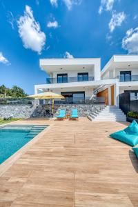 a villa with a swimming pool and a house at Inception Luxury Villas in Nea Skioni